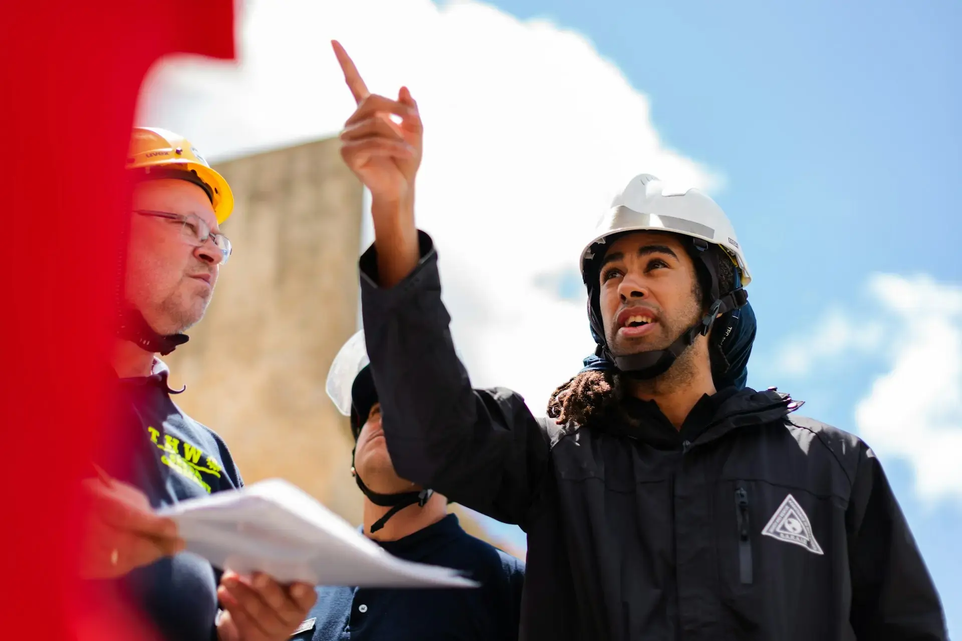 construction workers reviewing plans at a building site