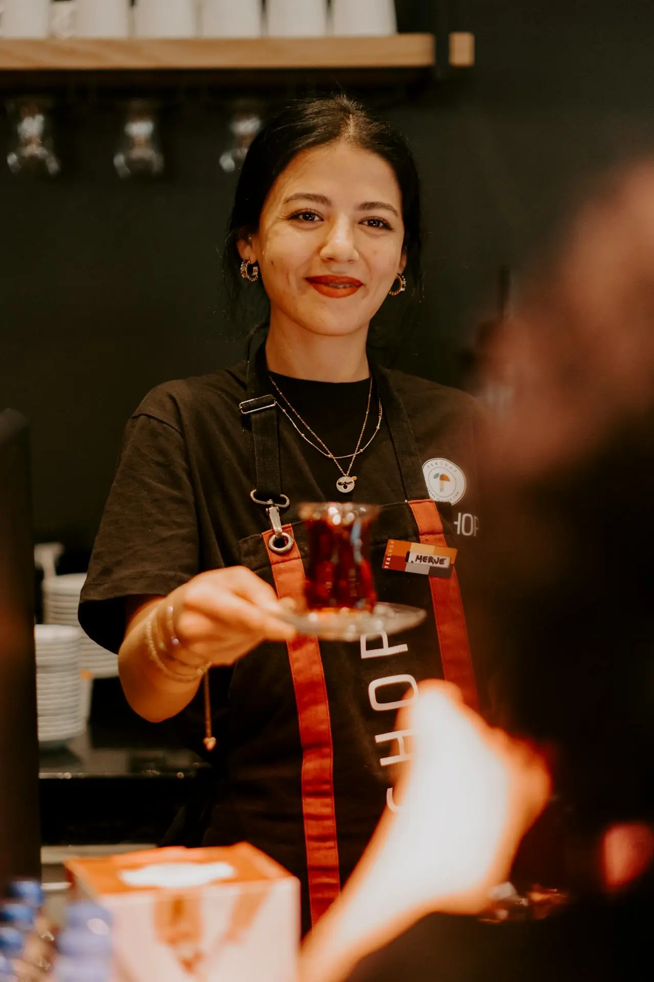 female small business owner serving customer in restaurant